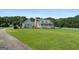 A lovely house featuring a well-maintained lawn and white picket fence that extends to the left of the property at 310 Trestle Rd, Locust Grove, GA 30248