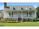 Charming front porch with a welcoming entrance, manicured landscaping, and a classic design at 310 Trestle Rd, Locust Grove, GA 30248