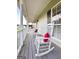 Comfortable front porch showcasing rocking chairs with red pillows, great for relaxing outdoors at 310 Trestle Rd, Locust Grove, GA 30248
