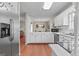 Open kitchen area, with white cabinets and stainless steel appliances at 310 Trestle Rd, Locust Grove, GA 30248