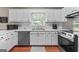 A kitchen with stainless steel appliances and white cabinetry and countertops at 310 Trestle Rd, Locust Grove, GA 30248