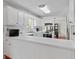 Kitchen view, showing white cabinets, countertops, and stainless steel appliances at 310 Trestle Rd, Locust Grove, GA 30248