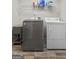 A laundry room featuring a washer, dryer, and storage shelves at 310 Trestle Rd, Locust Grove, GA 30248