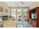 Inviting living room with large windows, comfortable seating, and a beautiful view of the outdoor patio at 310 Trestle Rd, Locust Grove, GA 30248
