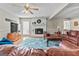 Cozy living room with a brick fireplace, hardwood floors, and plenty of natural light at 310 Trestle Rd, Locust Grove, GA 30248