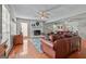 Spacious living room featuring a cozy fireplace, hardwood floors, and a comfortable leather couch at 310 Trestle Rd, Locust Grove, GA 30248