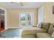 Cozy living room featuring a comfortable sofa, tiled flooring, and french doors leading to outdoor space at 310 Trestle Rd, Locust Grove, GA 30248