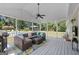 Relaxing covered patio featuring outdoor seating and a grill, overlooking the backyard and pool area at 310 Trestle Rd, Locust Grove, GA 30248