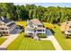 Expansive aerial view of home showcasing the landscaped lawn and the neighborhood's wooded surroundings at 27 Riverview, Euharlee, GA 30145