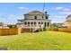 Exterior shot of a large home with outdoor deck overlooking a spacious backyard and wooden fence at 27 Riverview, Euharlee, GA 30145