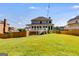 Large backyard featuring a well-maintained lawn, wooden fence, and an outdoor deck at 27 Riverview, Euharlee, GA 30145