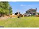 Spacious backyard with fire pit and mature trees, perfect for outdoor activities and relaxation at 27 Riverview, Euharlee, GA 30145