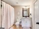 Bright bathroom featuring a granite vanity, framed mirror, and shower with a patterned shower curtain at 27 Riverview, Euharlee, GA 30145