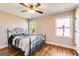 Bedroom features wood floors, a decorative metal bed frame, two windows and a ceiling fan at 27 Riverview, Euharlee, GA 30145