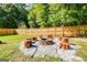 An outdoor fire pit surrounded by seating and pea gravel, perfect for entertaining and relaxation at 27 Riverview, Euharlee, GA 30145