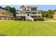 Charming two-story home with a large front yard and inviting wraparound porch with white railing at 27 Riverview, Euharlee, GA 30145
