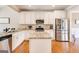 Elegant kitchen with white cabinetry, granite countertops, and stainless steel appliances at 27 Riverview, Euharlee, GA 30145