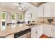 Open-concept kitchen with granite counters, white cabinetry, and stainless steel appliances at 27 Riverview, Euharlee, GA 30145