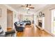 Bright living room featuring hardwood floors, ceiling fans, and a stone fireplace at 27 Riverview, Euharlee, GA 30145