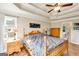 This main bedroom features a wooden bed frame, tray ceiling, and hardwood floors at 27 Riverview, Euharlee, GA 30145