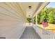 Spacious porch with white railings and hanging chair, perfect for enjoying the peaceful outdoors at 27 Riverview, Euharlee, GA 30145