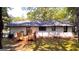 Back exterior of home showcasing wooden deck, white painted brick, and access to landscaped backyard at 5324 Joan Of Arc, Atlanta, GA 30349