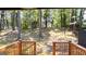 View of a lush backyard from a wooden deck, featuring mature trees and shaded areas at 5324 Joan Of Arc, Atlanta, GA 30349