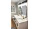 Bright bathroom featuring dual sink vanity, stone countertop, and modern lighting at 5324 Joan Of Arc, Atlanta, GA 30349