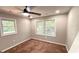 Bedroom with natural light from dual windows, complemented by a ceiling fan and neutral carpet at 5324 Joan Of Arc, Atlanta, GA 30349