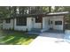 Charming home featuring a covered entrance, gray painted stairs and freshly cut lawn at 5324 Joan Of Arc, Atlanta, GA 30349