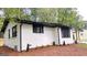 Exterior of house features landscaping, dark trim, and newly painted white brick at 5324 Joan Of Arc, Atlanta, GA 30349