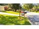 Well-maintained front yard with lush green lawn and 'For Sale' sign, situated in a quiet neighborhood at 5324 Joan Of Arc, Atlanta, GA 30349