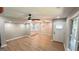 Bright, open-concept living room with hardwood floors and modern ceiling fan; adjacent to kitchen at 5324 Joan Of Arc, Atlanta, GA 30349