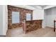 Finished basement features stone accent wall, bar area, and ample natural light at 230 Hummingbird Ct, Hampton, GA 30228