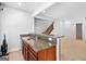 Basement wet bar featuring granite countertop, wood cabinets, and tiled floors at 230 Hummingbird Ct, Hampton, GA 30228