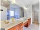 Bright bathroom featuring double vanity with wooden cabinets, soaking tub, and glass-enclosed shower at 230 Hummingbird Ct, Hampton, GA 30228