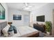 Modern bedroom with king bed, stylish furniture, ceiling fan, and decorative art at 230 Hummingbird Ct, Hampton, GA 30228