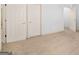 Spacious bedroom featuring carpeted floors, neutral walls, and multiple doorways at 230 Hummingbird Ct, Hampton, GA 30228