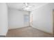 An empty bedroom features neutral carpeting, a ceiling fan, and ample natural light at 230 Hummingbird Ct, Hampton, GA 30228