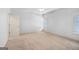 A large bedroom featuring neutral walls, carpeted floors, and natural light from two windows at 230 Hummingbird Ct, Hampton, GA 30228