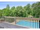 The backyard deck provides a relaxing view of the in-ground pool and fenced backyard at 230 Hummingbird Ct, Hampton, GA 30228