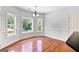Dining area with hardwood floors, three windows, and a chandelier at 230 Hummingbird Ct, Hampton, GA 30228