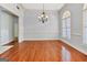 Dining room with hardwood floors, a chandelier, and large windows at 230 Hummingbird Ct, Hampton, GA 30228