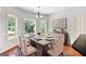Formal dining room with a large dining table, chairs, and large windows at 230 Hummingbird Ct, Hampton, GA 30228