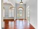 Bright foyer featuring hardwood floors, transom windows, and a decorative front door at 230 Hummingbird Ct, Hampton, GA 30228