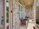 Covered front porch with chairs and table at 230 Hummingbird Ct, Hampton, GA 30228