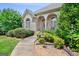 Brick home with manicured shrubbery, beautiful lawn and walkway leading to front door at 230 Hummingbird Ct, Hampton, GA 30228