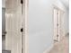 Hallway with white doors showcases the home's layout and access to different rooms at 230 Hummingbird Ct, Hampton, GA 30228
