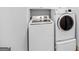 Modern laundry room with side-by-side washer and dryer at 230 Hummingbird Ct, Hampton, GA 30228