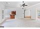 Open-concept living room with a view of the kitchen and adjacent rooms at 230 Hummingbird Ct, Hampton, GA 30228